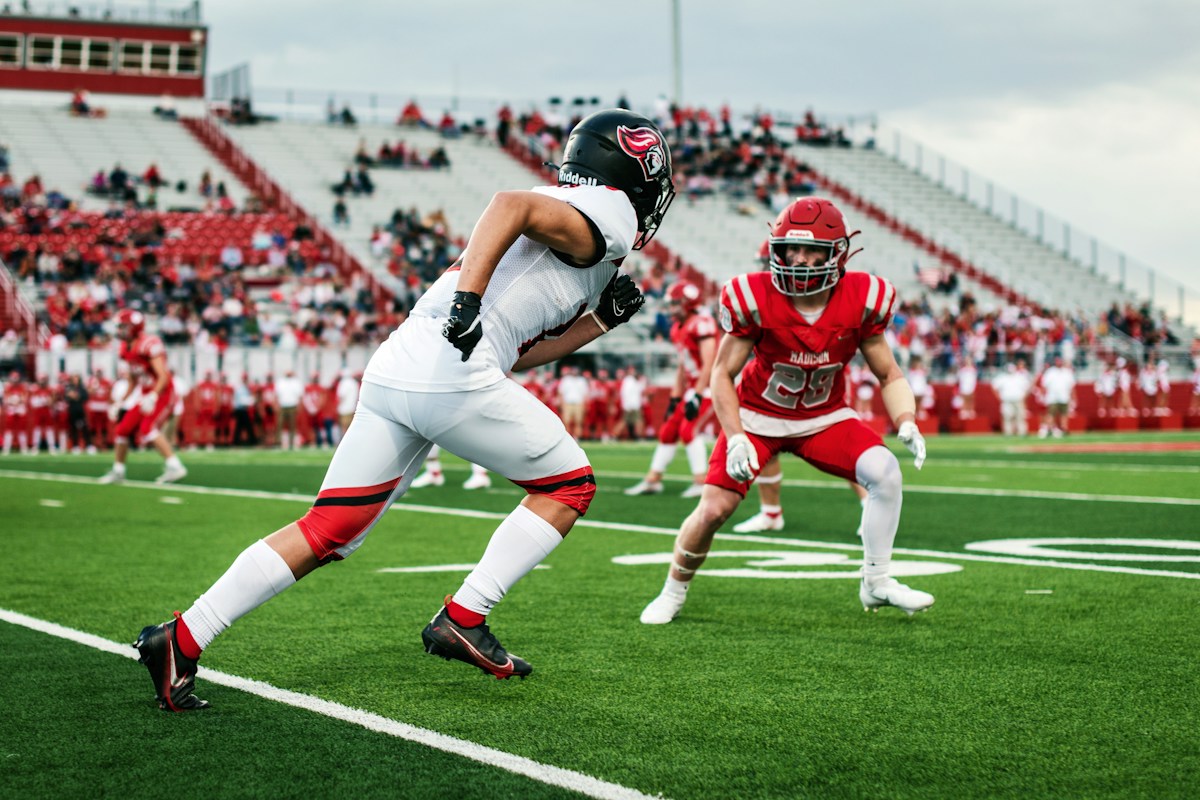 High school football players on the field illustrating recruiting evaluations